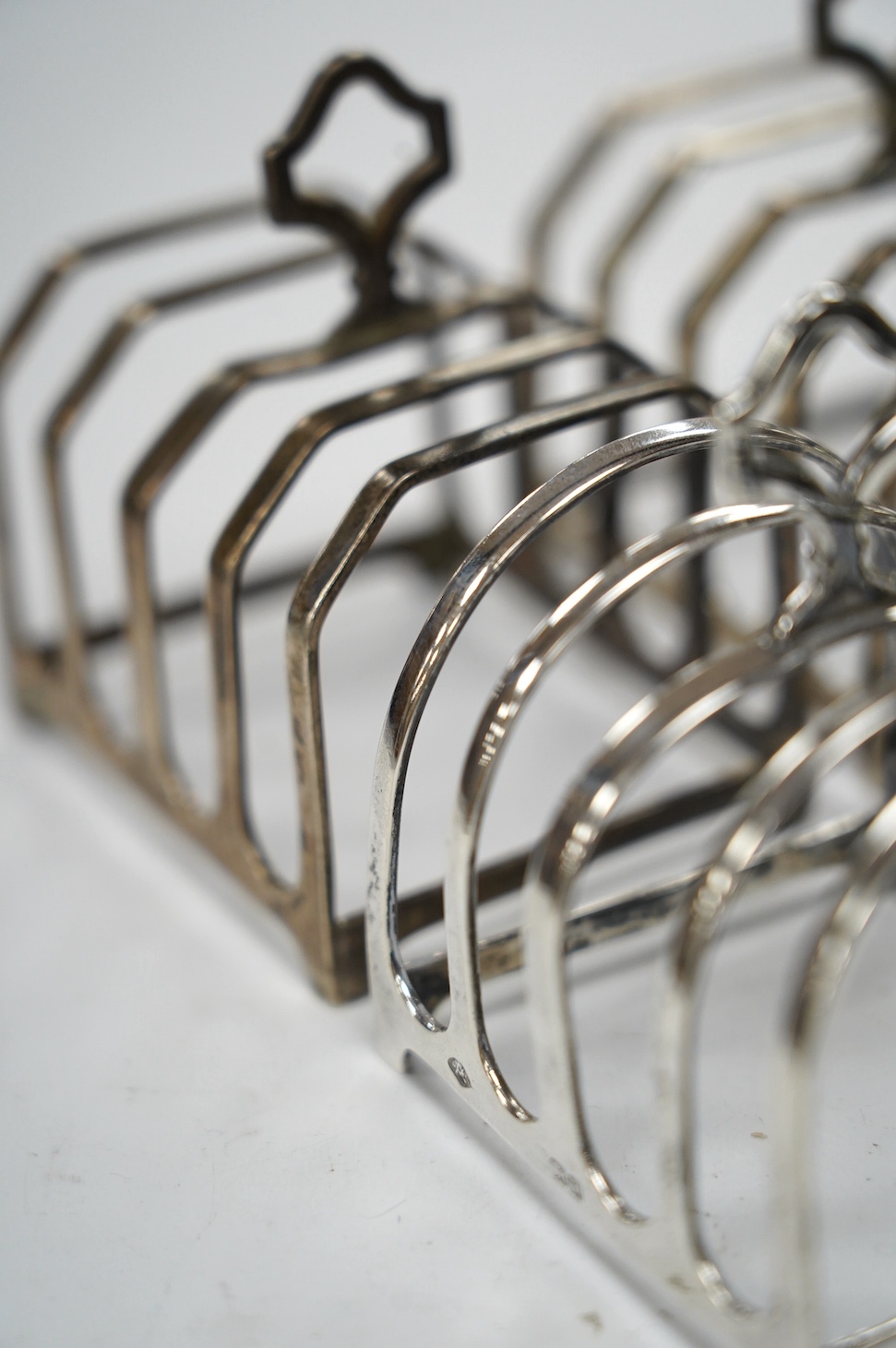 Two pairs of silver five bar toast racks, Birmingham, 1931 and Birmingham, 1932, 75mm, 10.7oz. Condition - fair